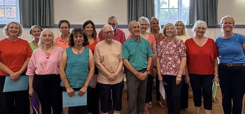 Ardingly Community Choir members smiling in a group photo.